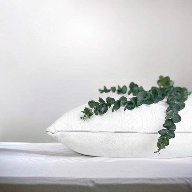 White OnePillow Pillow on a Light Bed