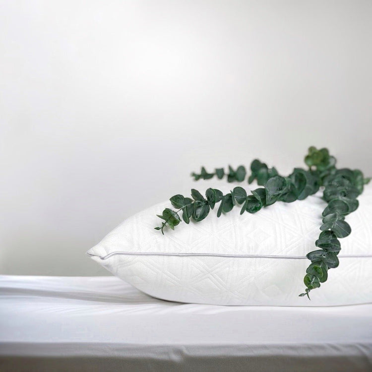 White OnePillow Pillow on a Light Bed